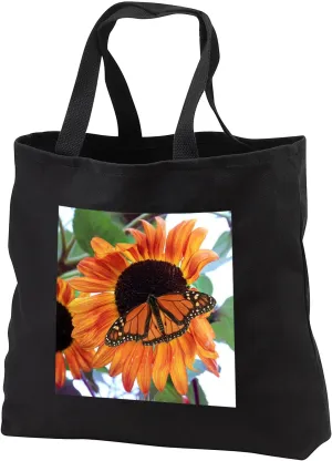 3dRose Photograph of a male monarch butterfly on an orange and red... - Tote Bags (tb_327120)